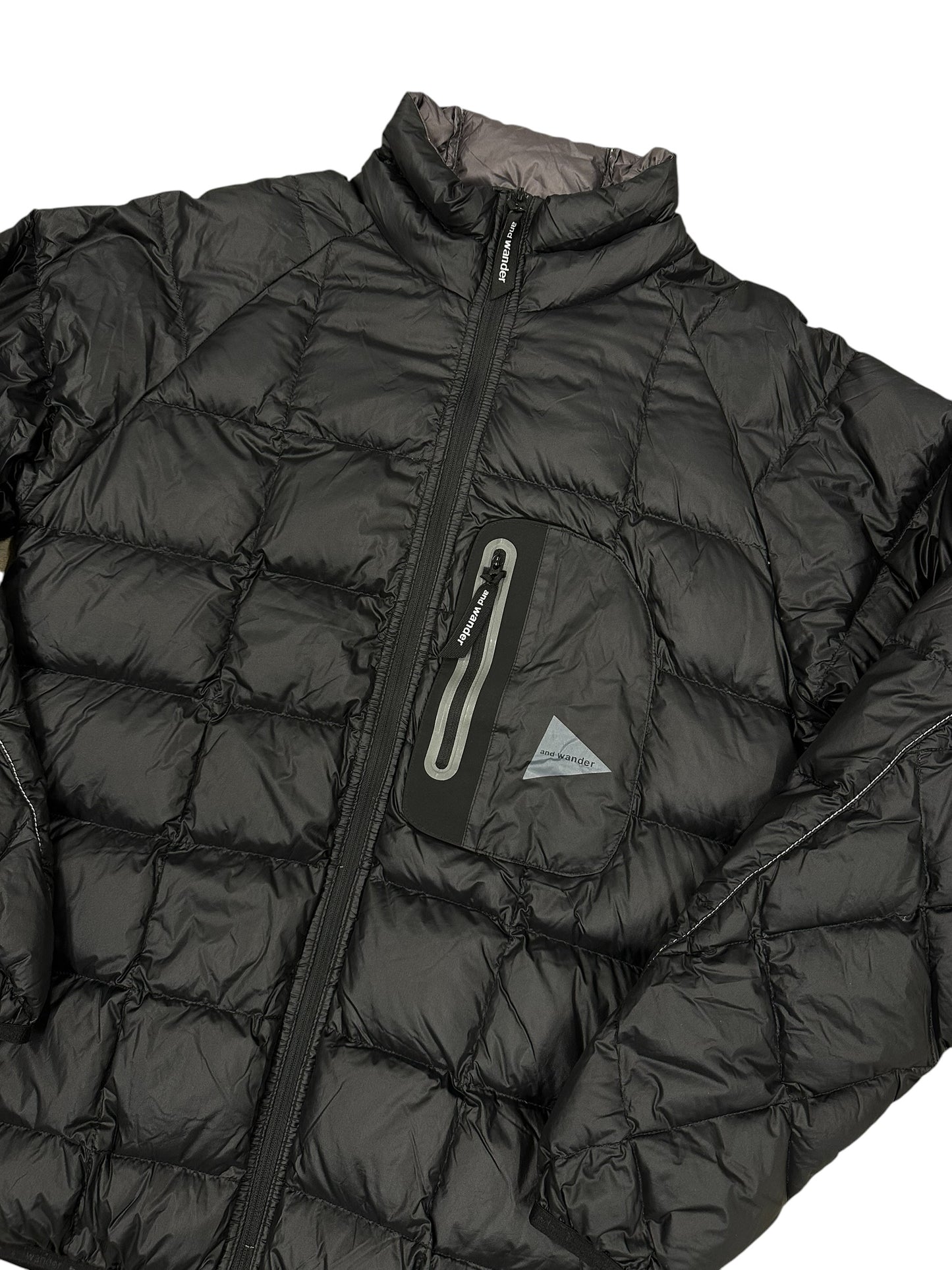 Chaqueta acolchada negra And Wander técnica ligera